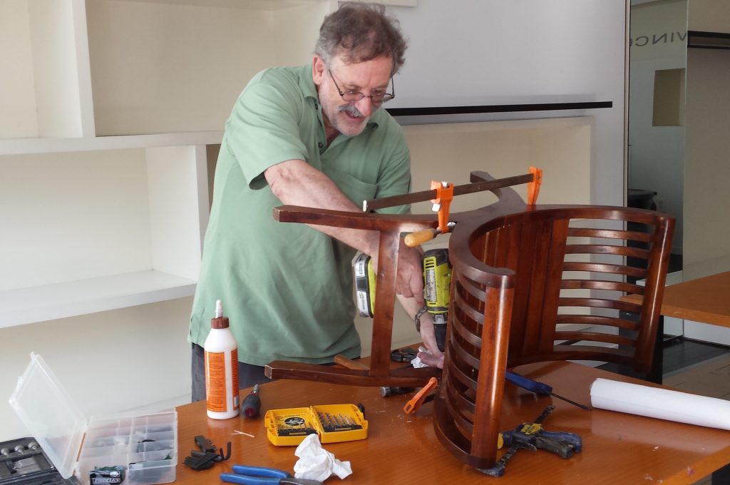 man repairing chair