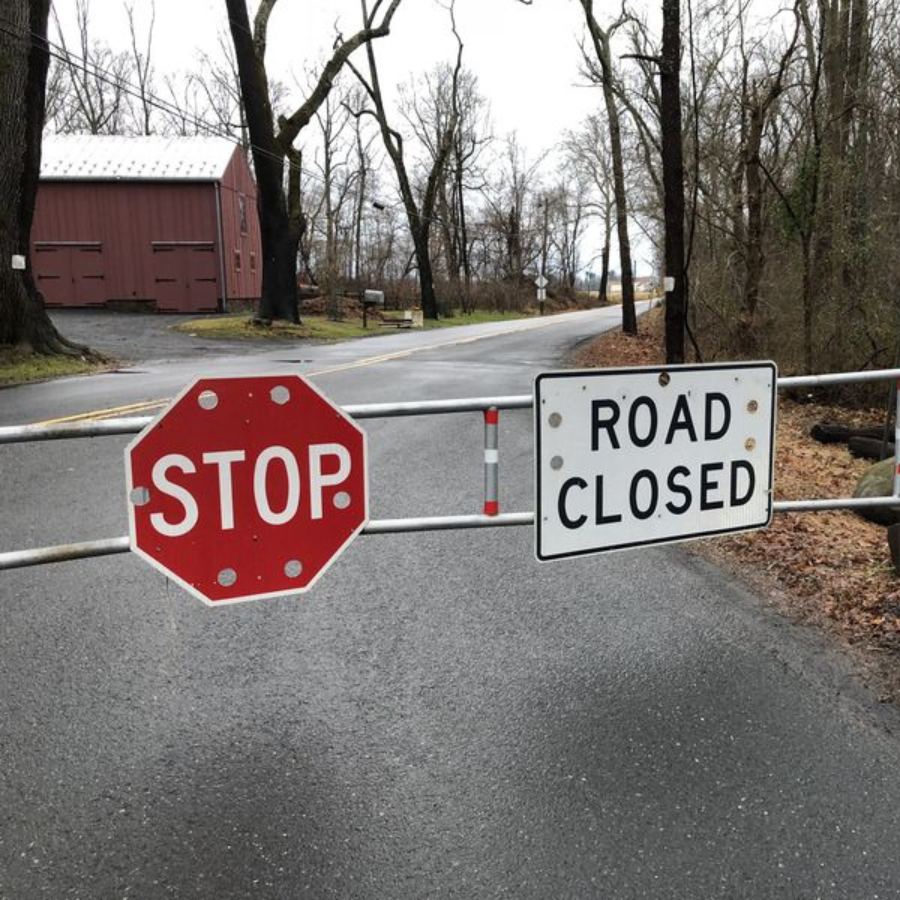 road closure signage and stop sign at a road
