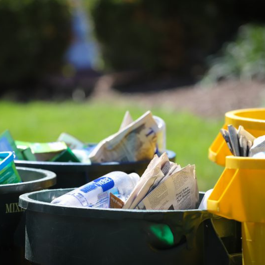recycling bins with recycling items in them